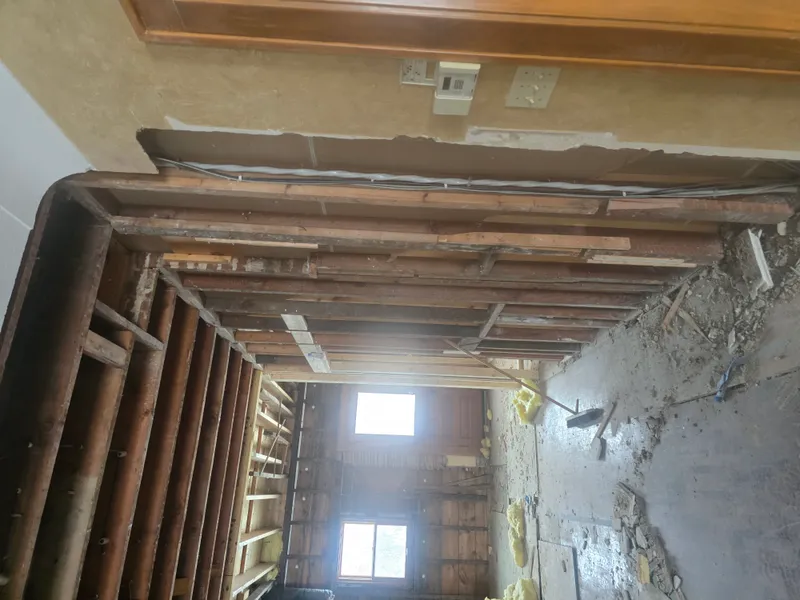 Gutted room with exposed framing ready for debris removal