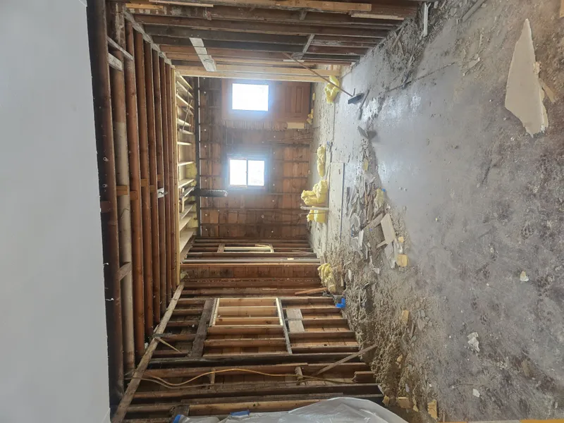 Floor torn up revealing joists — construction debris removal job
