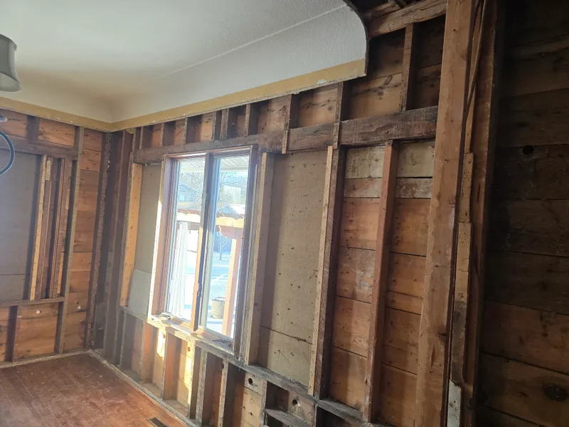 Garage cleanout — interior walls exposed after clearing junk and debris