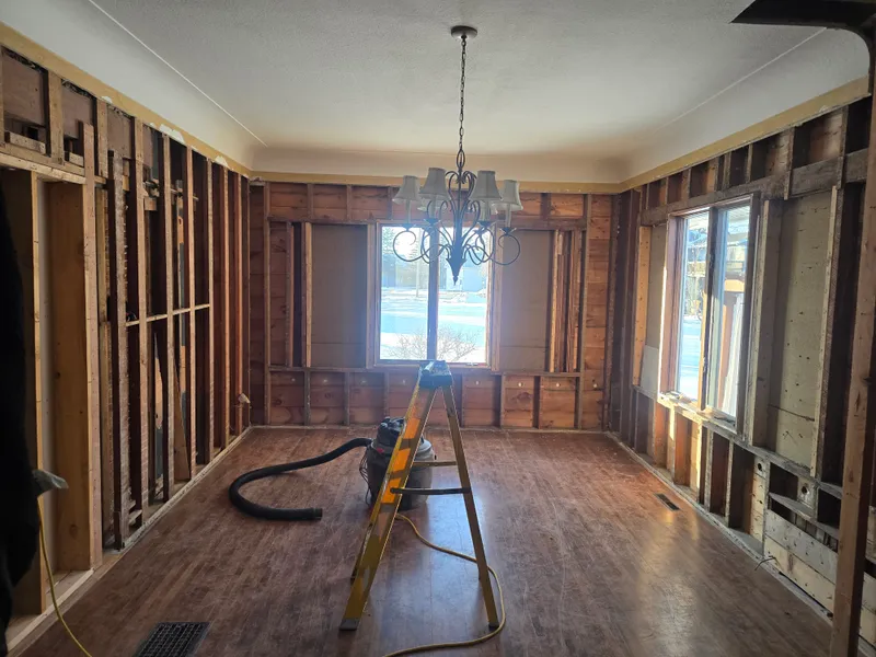 Garage cleanout in progress — walls and floor cleared
