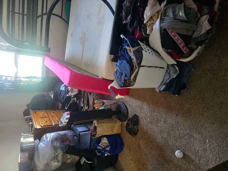 Cluttered room with furniture piled high before cleanout